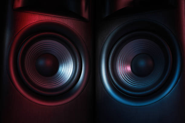 istock Modern sound speakers in neon light as background, closeup 1929009119