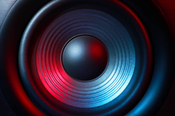 One sound speaker in neon light as background, closeup