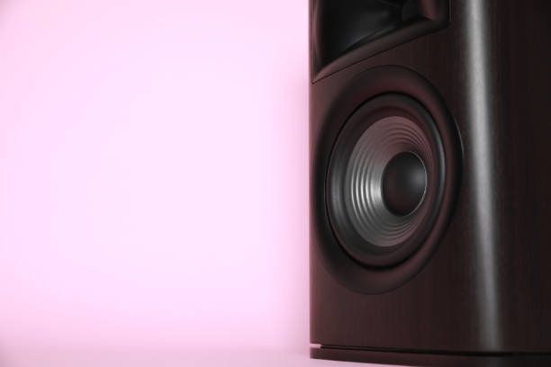 istock One wooden sound speaker on pink background, closeup. Space for text 1929011167