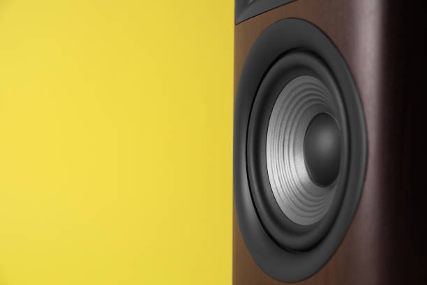 One wooden sound speaker on yellow background, closeup. Space for text