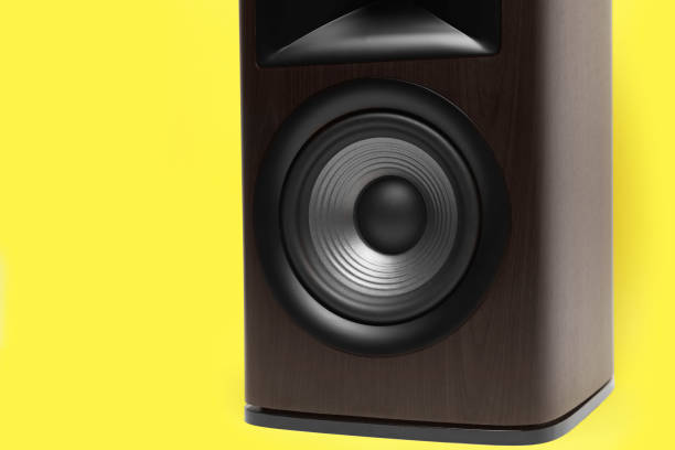 istock One wooden sound speaker on yellow background, closeup. Space for text 1929012710