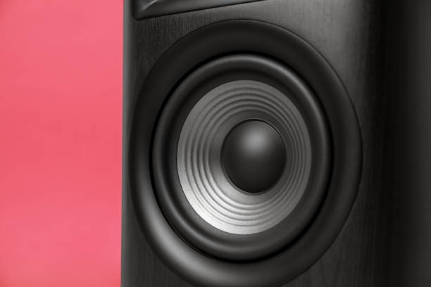 istock One wooden sound speaker on red background, closeup 1929013226
