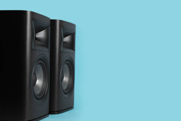 istock Wooden sound speakers on light blue background. Space for text 1929014283