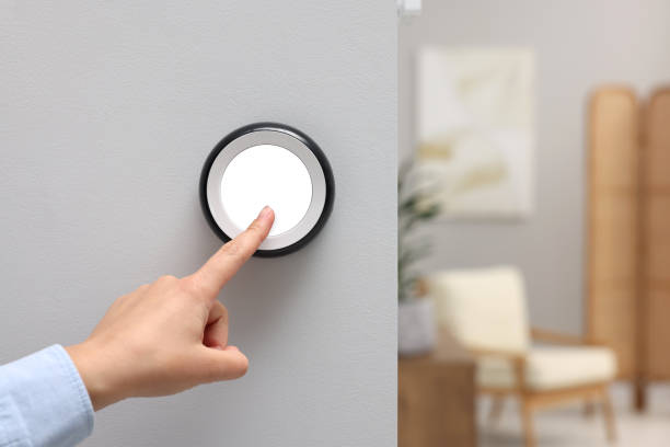 istock Woman adjusting thermostat on white wall indoors, closeup and space for text. Smart home system 1929014292