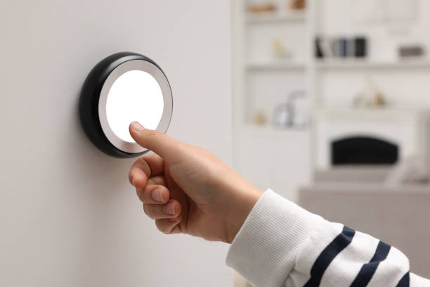 istock Woman adjusting thermostat on white wall indoors, closeup. Smart home system 1929015330