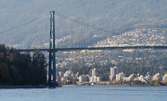 Beautiful view of the Lions Gate Bridge connecting the North Shore with Downtown Vancouver as seen from Stanley Park during a fall season in Vancouver, British Columbia, Canada.