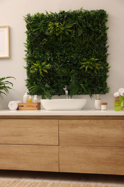 istock Green artificial plants, vanity and different personal care products in bathroom 1929062900