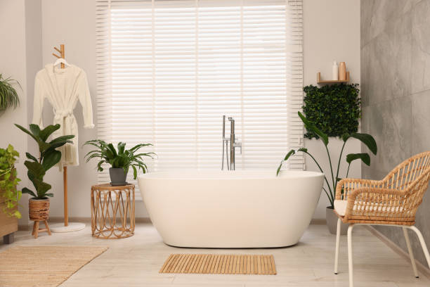 istock Green artificial plants, robe and tub in bathroom 1929064436