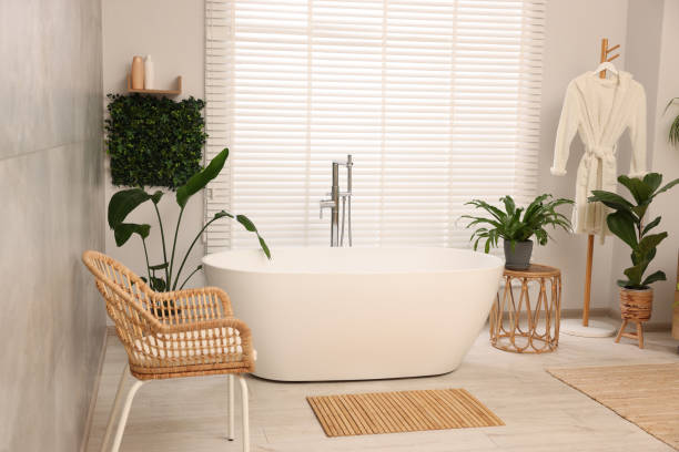 istock Green artificial plants, robe and tub in bathroom 1929065971