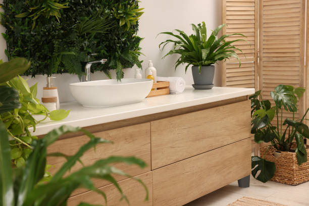 istock Green artificial plants, vanity and different personal care products in bathroom 1929065973