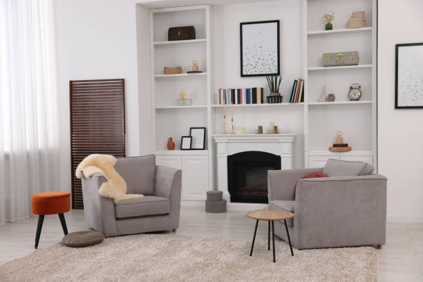 istock Comfortable armchairs, fireplace and shelves in living room. Interior design 1929066482