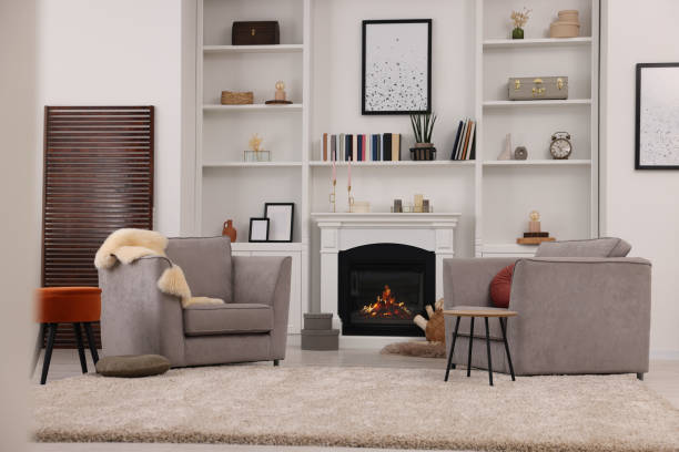 istock Comfortable armchairs, fireplace and shelves in living room. Interior design 1929066488