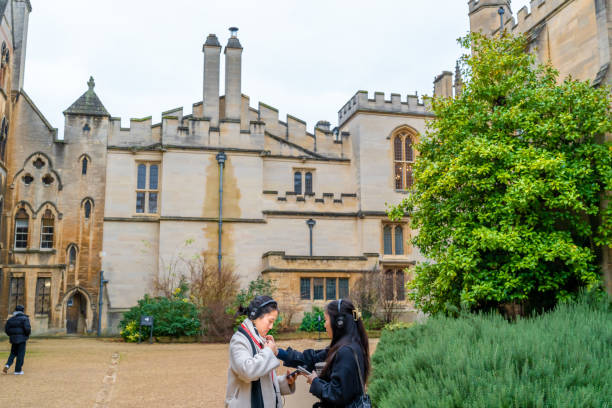 A  young woman are traveling together and visiting Oxford University  in UK.