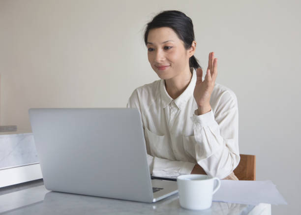 istock Asian female entrepreneur greeting partners on tech web conference 1929150658