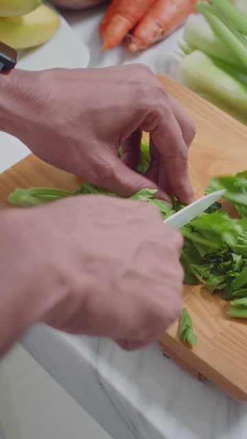 Hands of Cook Cutting Parsley for Salad