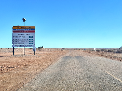 Road conditions information sign at the starting point of the Oodnadatta track in Marree, an unsealed 614 km outback road in South Australia.