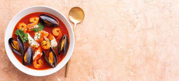 Bouillabaisse soup with fish, mussels and shrimps. French cuisine. Seafood