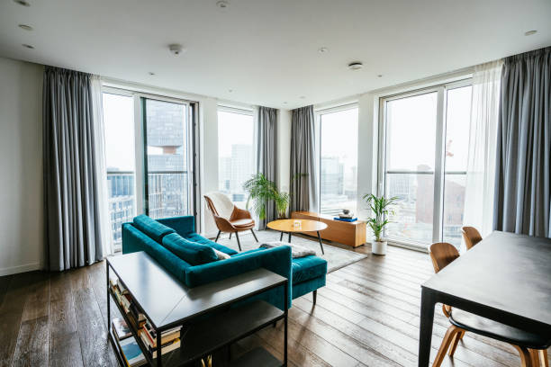 modern apartment with large windows - apartman stok fotoğraflar ve resimler