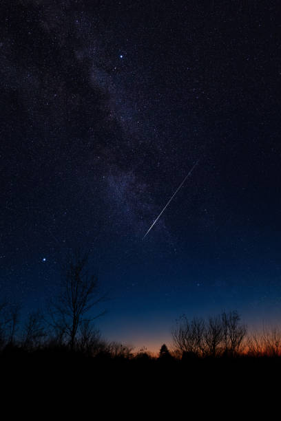 istock Shooting star, Milky way and landscape silhouettes. 1929371850