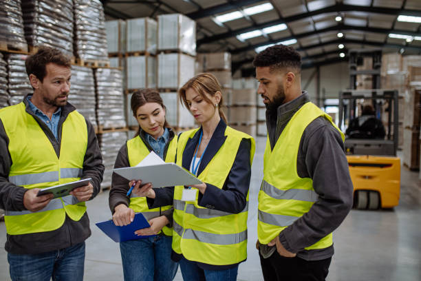 istock Warehouse workers reading product order, order picking. Warehouse manager checking delivery, stock in warehouse, inspecting products for shipment. 1929420129