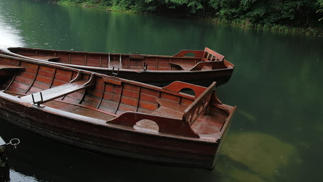 Old brown rowing boats moored on the mountain lake. Close Up view