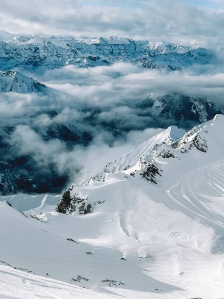 istock Snowy Alps in the clouds on a sunny day, mountains 1929469270