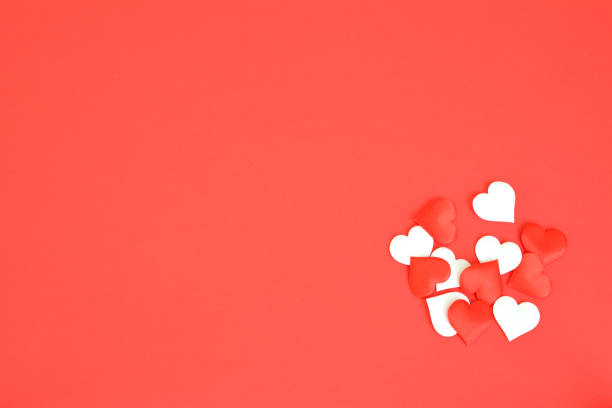 istock heap of white and red hearts on red background copy space 1929525408