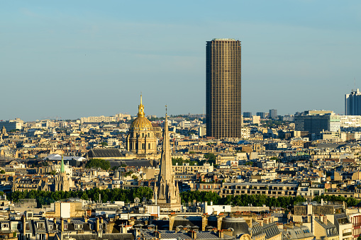 This landscape photo was taken, in Europe, in France, in ile de France, in Paris, in summer. We see the American Cathedral, the Invalides and the Montparnasse tower, under the Sun.