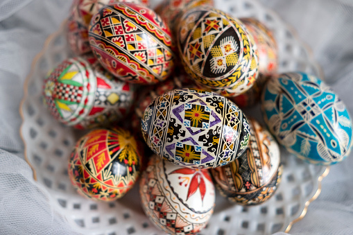 Intricate Easter eggs, part of the Northern Romanian custom of wax coloring and painting elaborate traditional symbols and motifs on the eggshell with a special tool, a drawing pen known as \