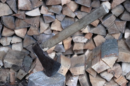 an ax and a pile of firewood