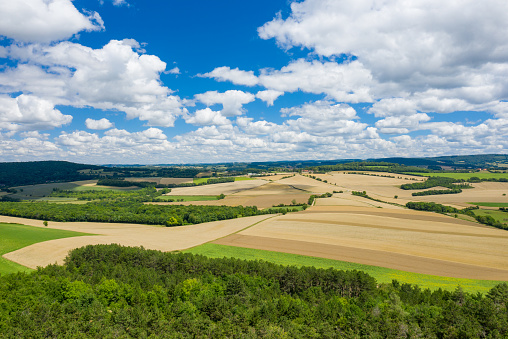 This landscape photo was taken in Europe, in France, in Burgundy, in Nievre, near Chateau Chinon, in summer. We see the countryside with its forests and green fields, under the Sun.