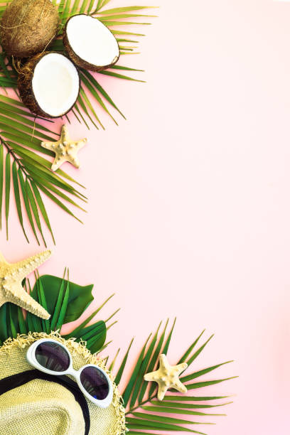 istock Summer vacation on pink with palm leaves and accessories. 1929553576
