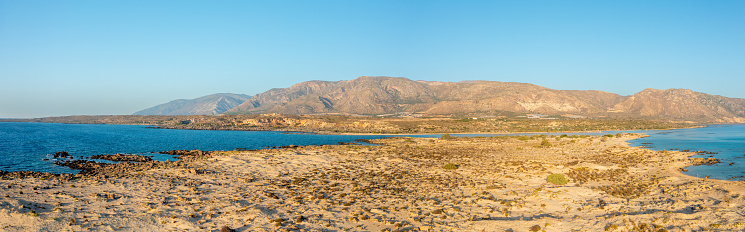 This landscape photo was taken, in Europe, in Greece, in Crete, in Elafonisi, By the Mediterranean sea, in summer. You can see the nature reserve and its fine white sand, under the sun.