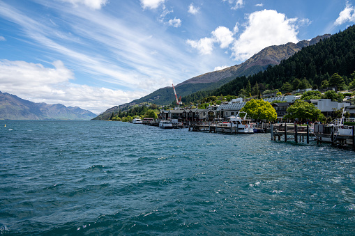 Experience Queenstown's enchanting waterfront, where boats, restaurants, and stunning lakeside views create a picturesque setting in New Zealand.