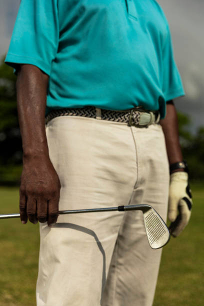 istock Golfer holding golf club 1929569246