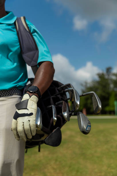 istock Caddie carryinfg golf clubs 1929570351