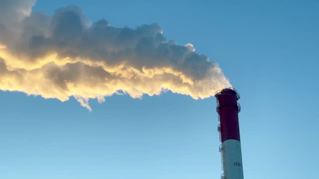 chimney smoke against a blue sky