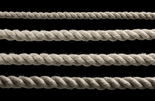 collection of various ropes string on black background. each one is shot separately.