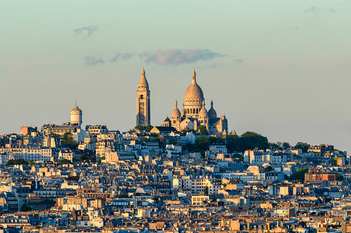 This landscape photo was taken, in Europe, in France, in ile de France, in Paris, in summer. We see the Basilica of the Sacred Heart on the Montmartre hill, under the Sun.