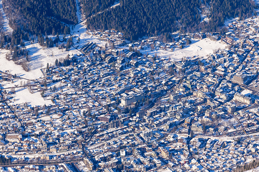 This landscape photo was taken in Europe, in France, Rhone Alpes, in Savoie, in the Alps, in winter. We see the town of Chamonix, under the sun.