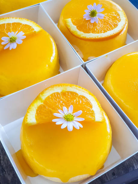 Orange cake with sliced orange and edible flower on top