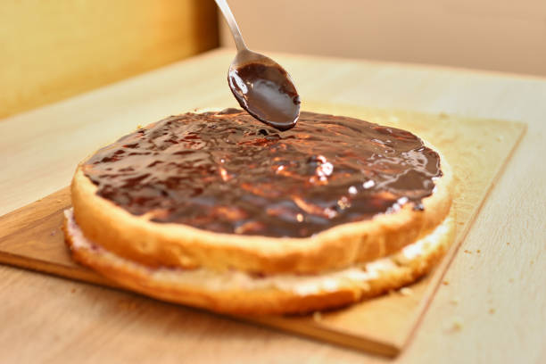 istock Chocolate cake decoration. Cooking a festive pie at home 1929628011