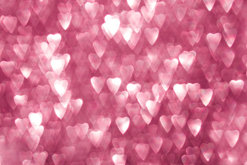 Valentine's Day background made of out-of-focus bokeh in the shape of hearts
