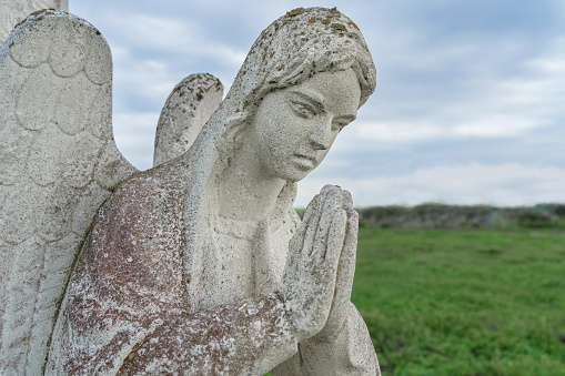 Angel woman in prayer (concept: loss, death)