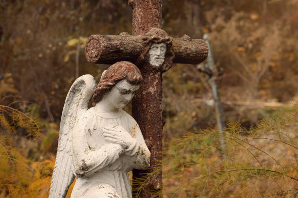 Statue of angel with hand raised in sunlight, from cemetery build in 1864, Czech Republic, background with copy space, full frame horizontal composition