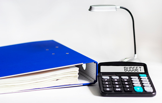Budgeting and budget calculation or analysis. Word budget on calculator and white background