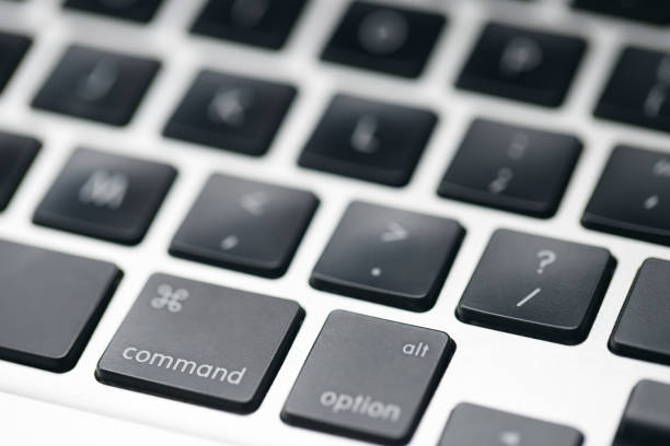 Close-up photo of a modern laptop keyboard captured in dramatic natural light and shadow. The image highlights clean lines and minimalist design, creating an abstract tech composition ideal for themes like remote work, digital tools, modern business environments, cybersecurity, and creative tech backdrops.