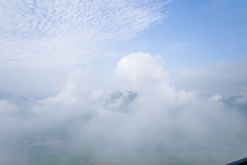 This landscape photo was taken, in Asia, in Vietnam, in Tonkin, towards Hanoi, in Mai Chau, in summer. We see the valley dominated by clouds and fog in the middle of the mountains, under the Sun.