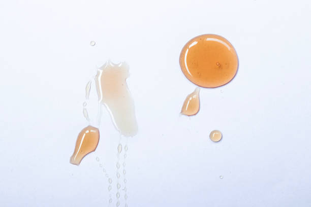 istock Honey drops isolated on white background close up. 1929683270
