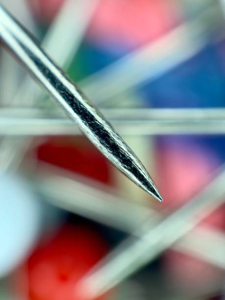 A number of stainless safety pins on white background.